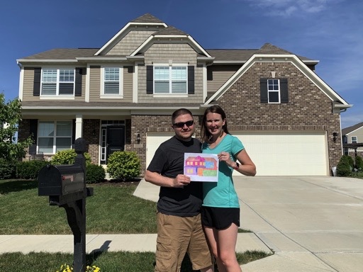 Mrs. Lemon and I standing in front of our home with our mortgage visualization fully colored in because we had just paid the mortgage off.